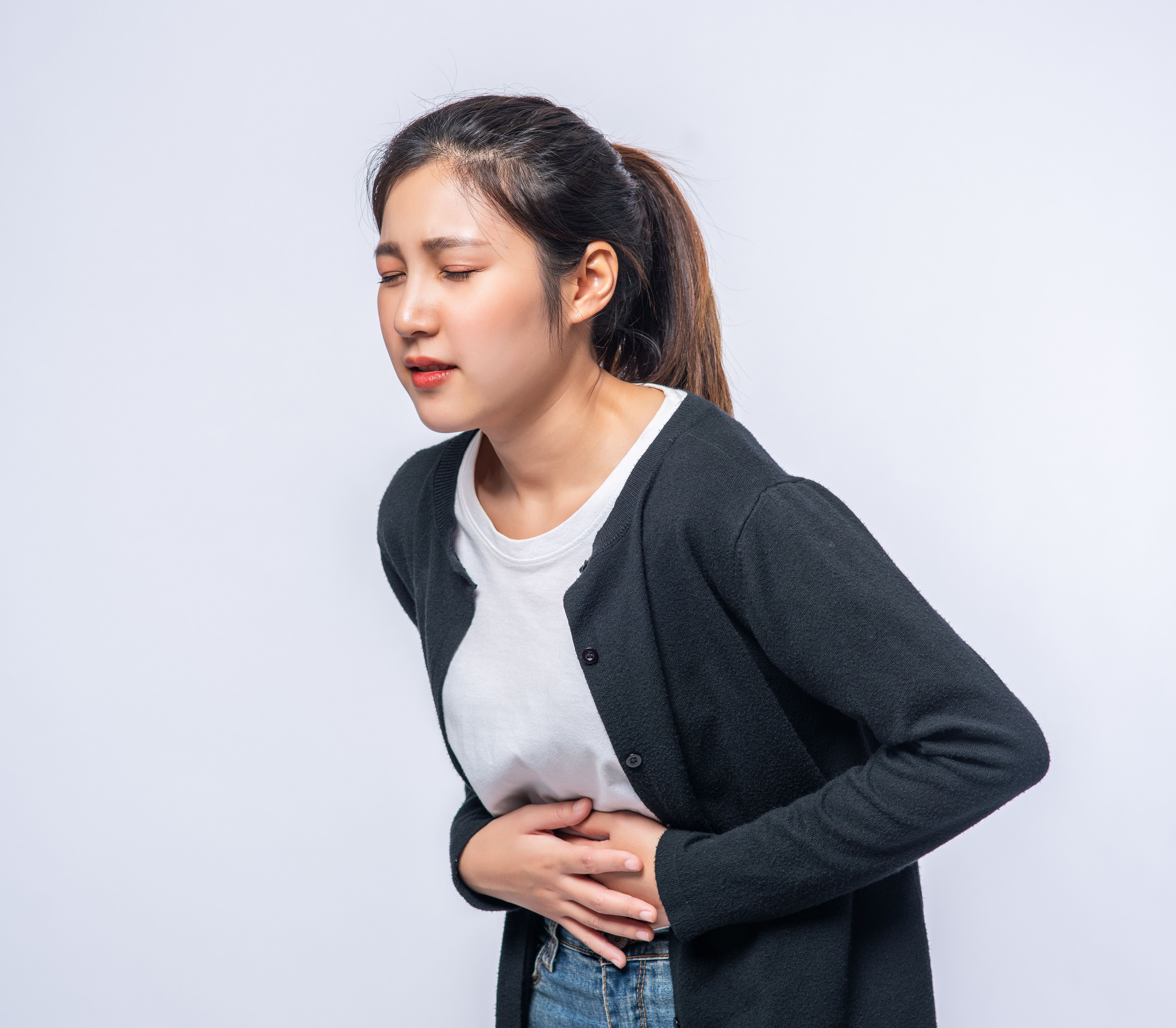 woman-standing-with-stomach-ache-presses-her-hand-her-stomach.jpg